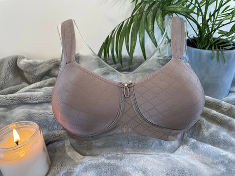 Julie Mastectomy Bra in taupe with wire-free design, adjustable straps, and soft fabric. Features deep pockets for post-surgery comfort.