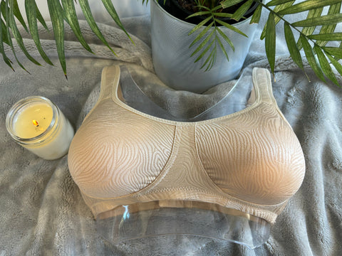 Front on picture of our wire-free mastectomy bra, Lucielle. Lucielle is a nude bra with shiny jacquard.