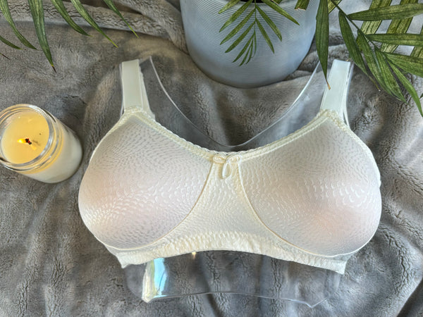 Eve Wire-Free Mastectomy Bra in soft white with breathable mesh pockets, adjustable straps, and seamless design for post-surgery comfort.