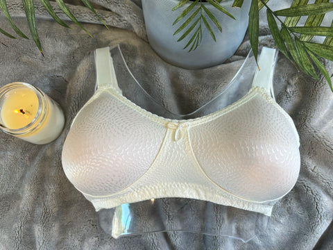 Eve Wire-Free Mastectomy Bra in soft white with breathable mesh pockets, adjustable straps, and seamless design for post-surgery comfort.